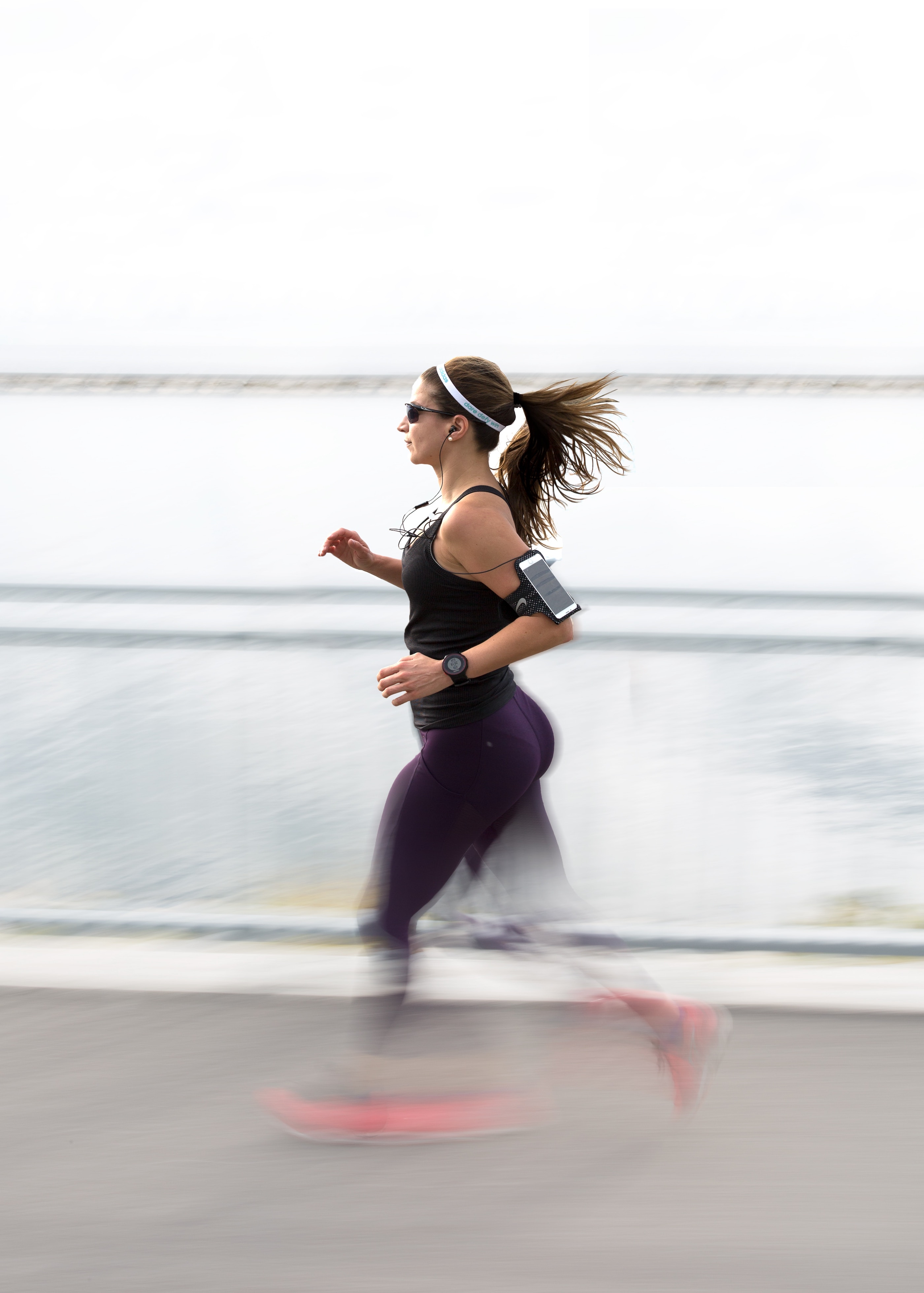 woman running wearing a fitness tracker